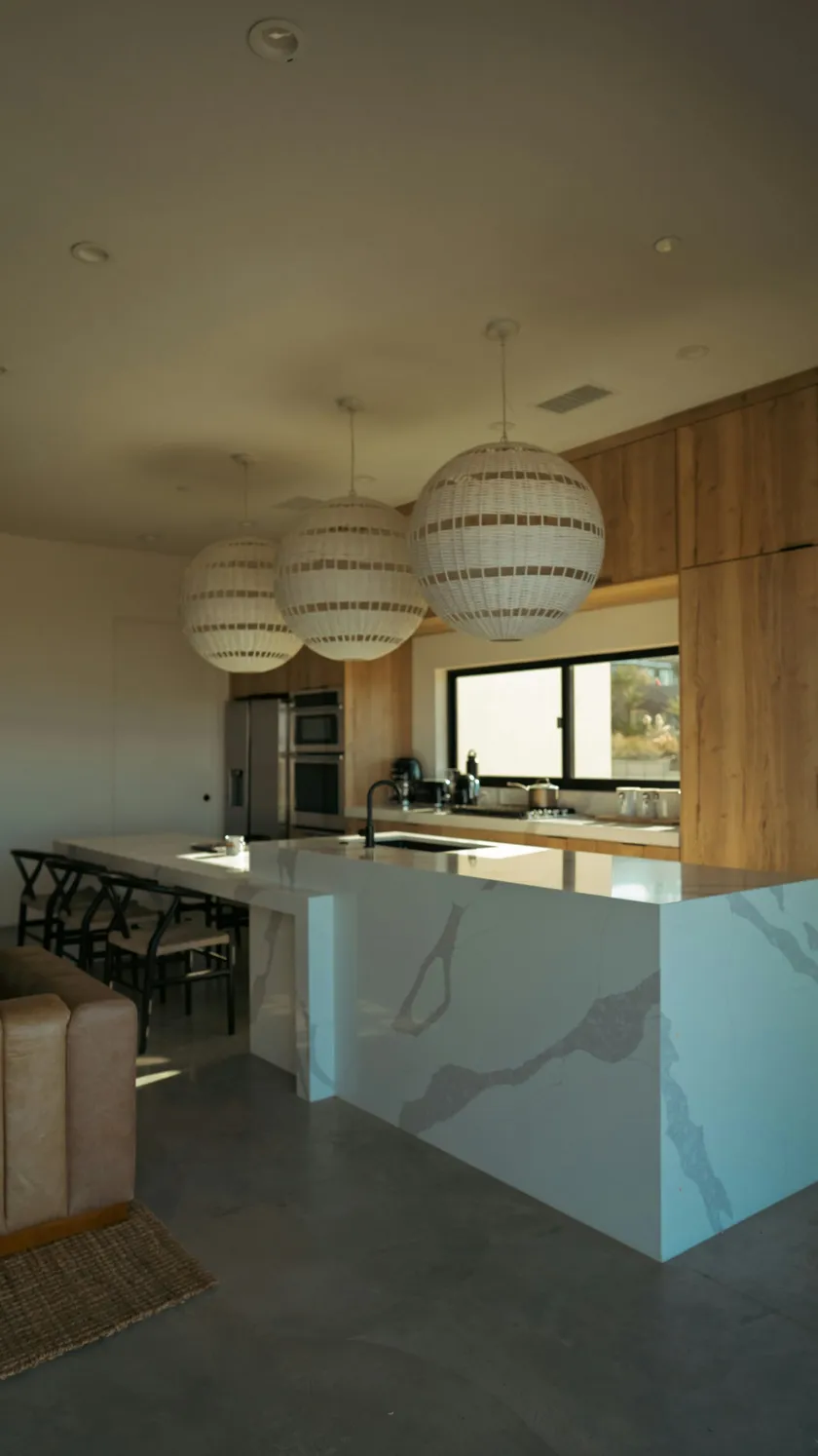 White quartz kitchen island with waterfall edges and bold gray veining in Marietta, GA